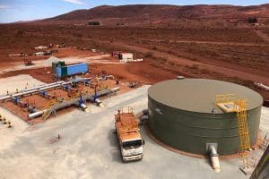 Circular coloured steel tank on mine site