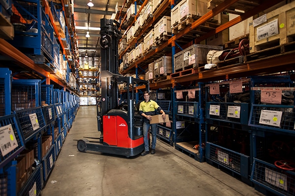 Man carrying box in Allied Pumps warehouse